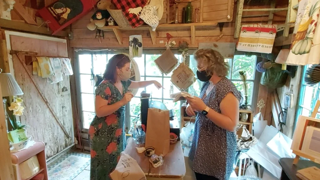 Deux femmes masquées dans une boutique artisanale