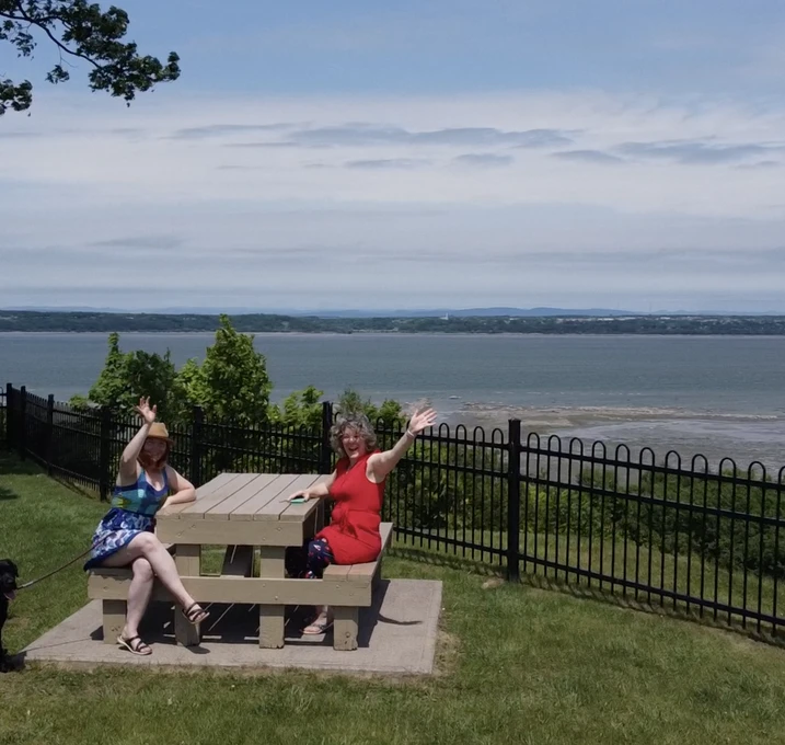 Deux femmes saluant à table face à la mer